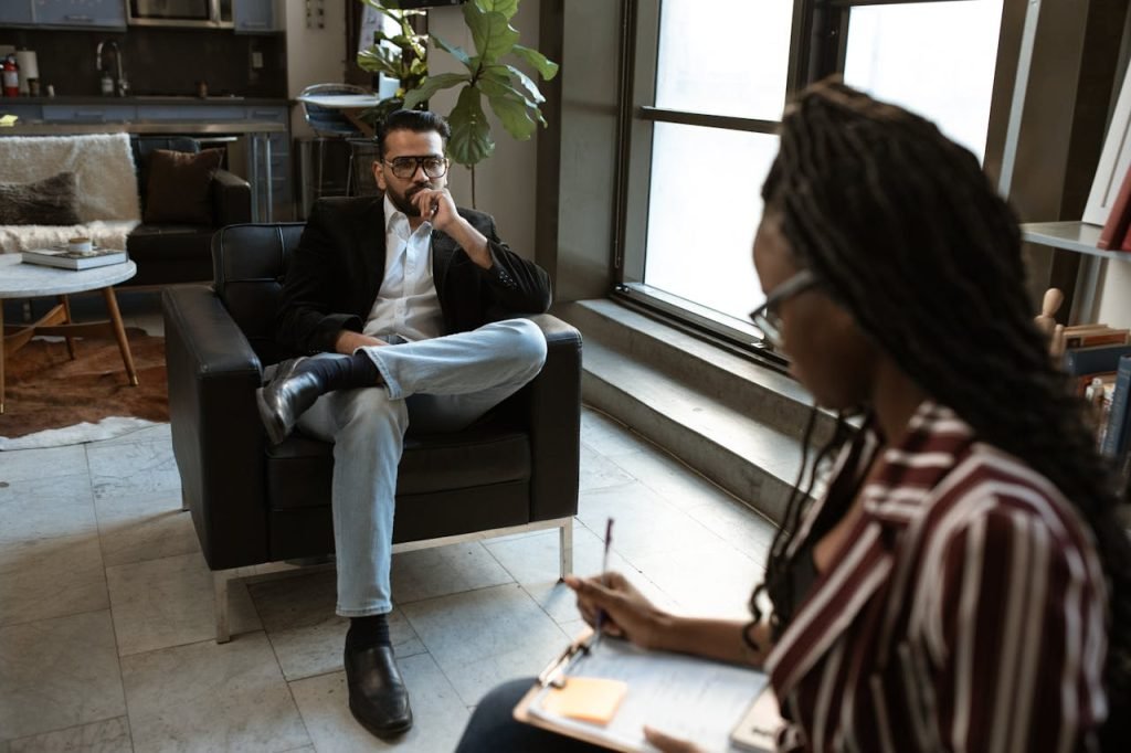 A man and woman engaged in an interview in a stylish modern office.